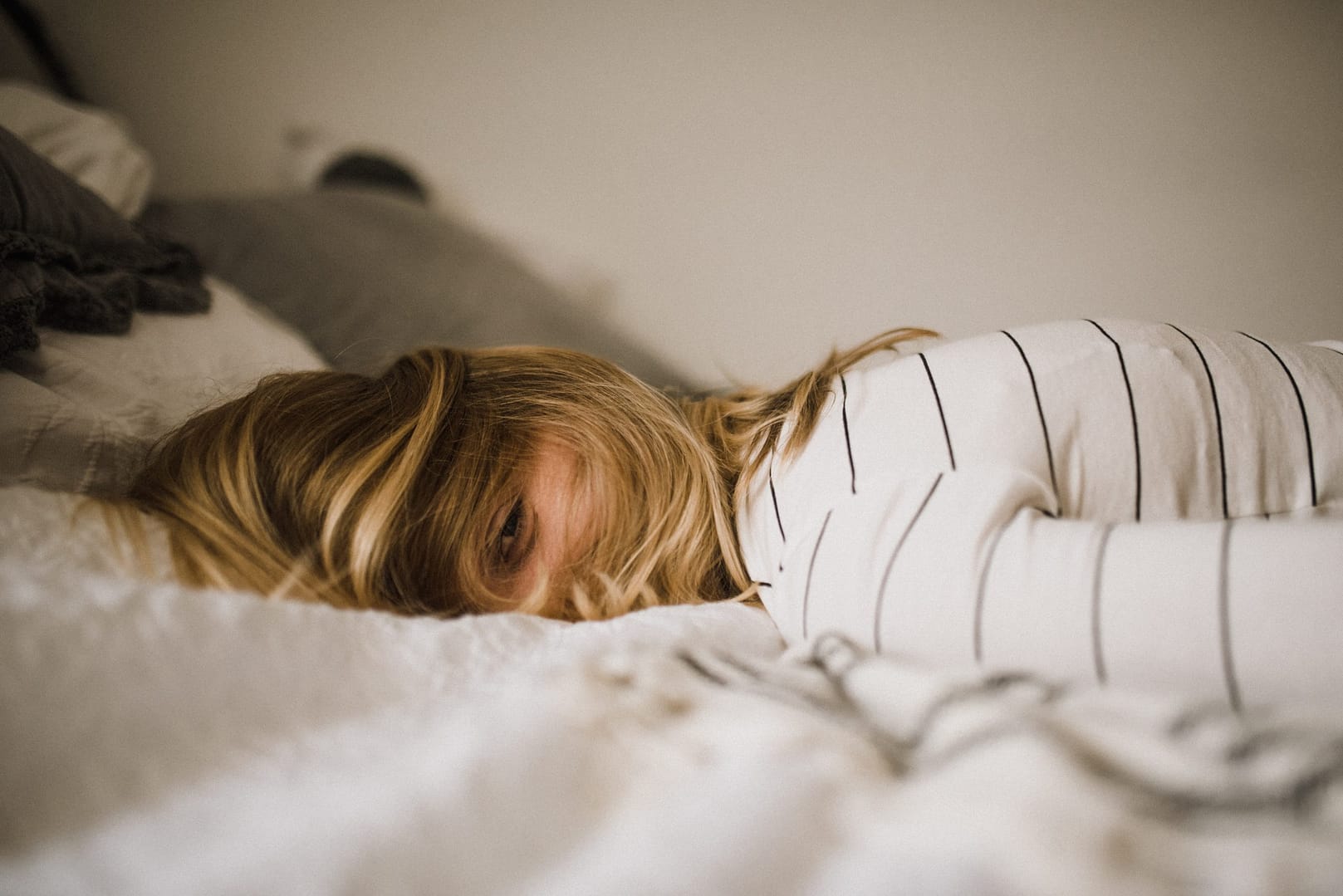 Graphic of Woman laying on bed with fatigue